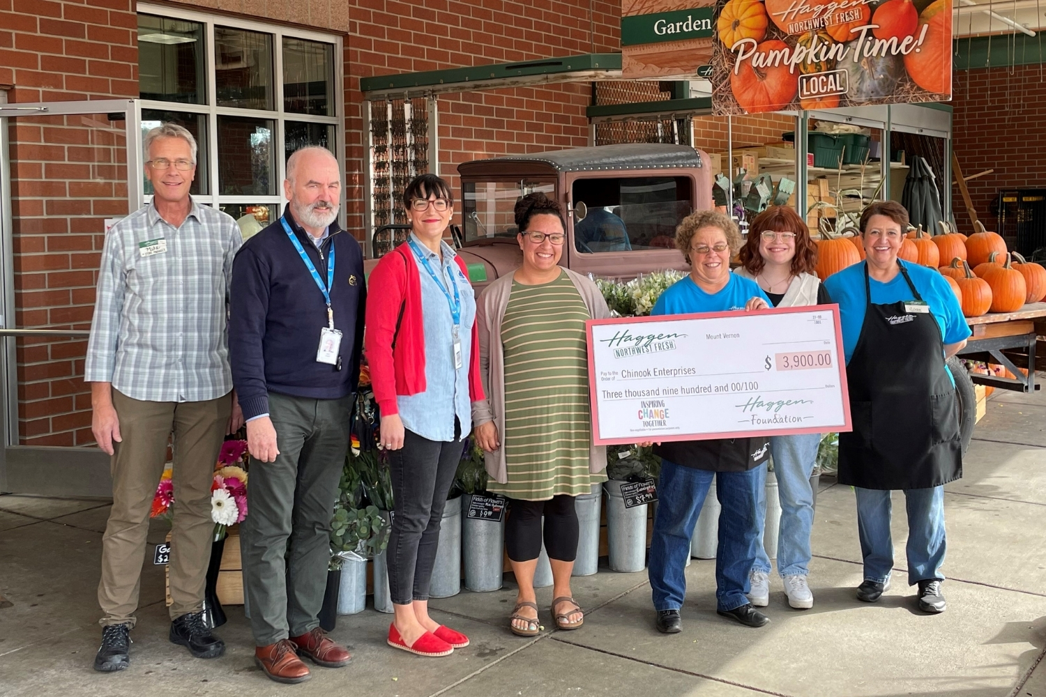 group of people with large check